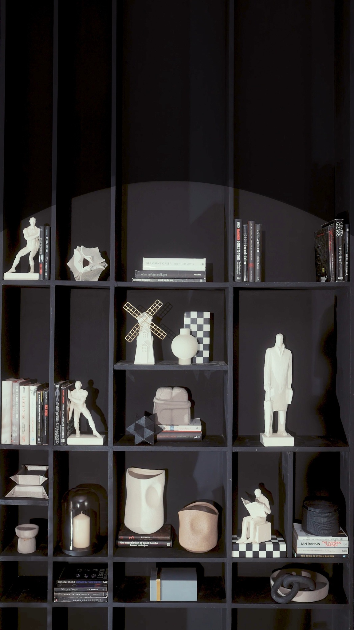 Coffee table books, a pillar candle, Checkered stands, a table accent All the details that put the show in showcas...