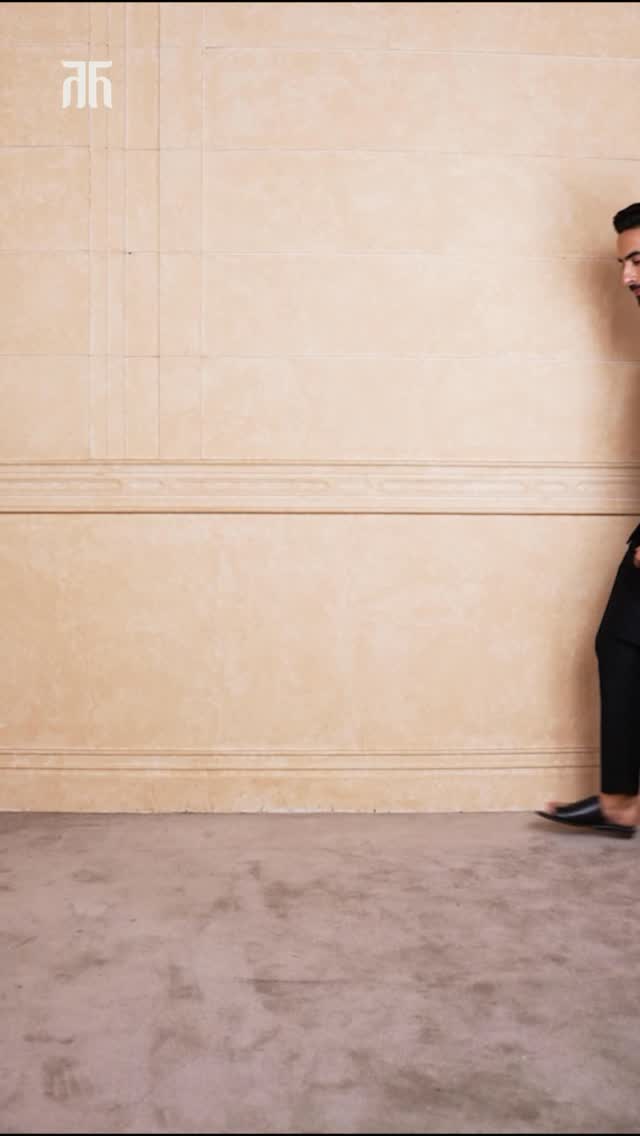 Dark green, black, and brocade finesse a festive fit that carries tradition with a modern edge