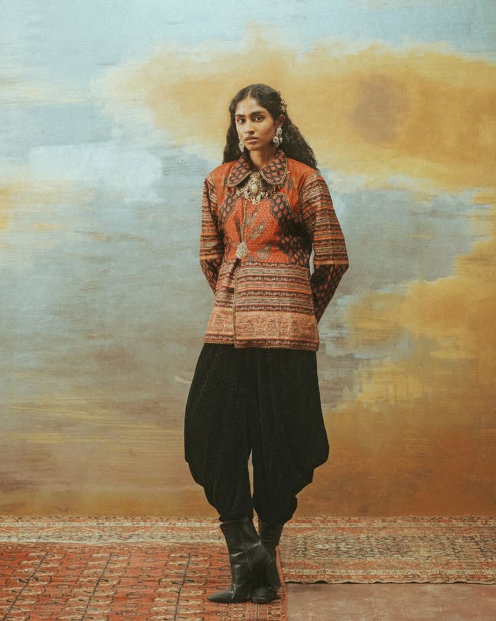 Perfectly paired with a set of flowy black pants, this silk jacket is printed with a multitude of paisleys