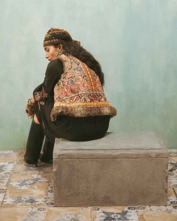 Lined with velvet and adorned with heritage motifs, this jacket is paired here with a long dress