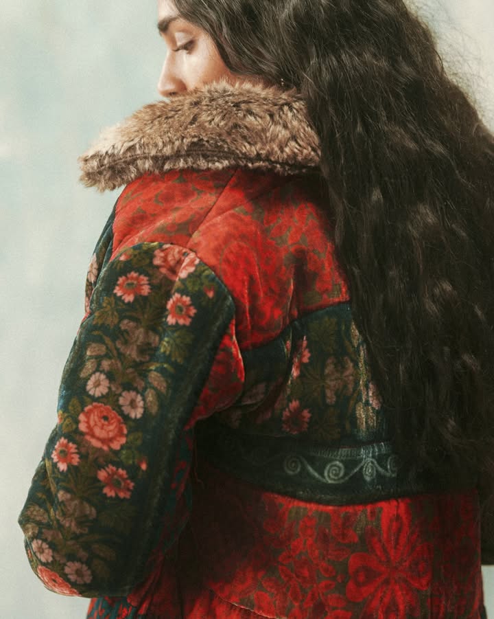 A silk jacket printed with fuschia florals, this creation is lined with fur. Perfect for long winter nights