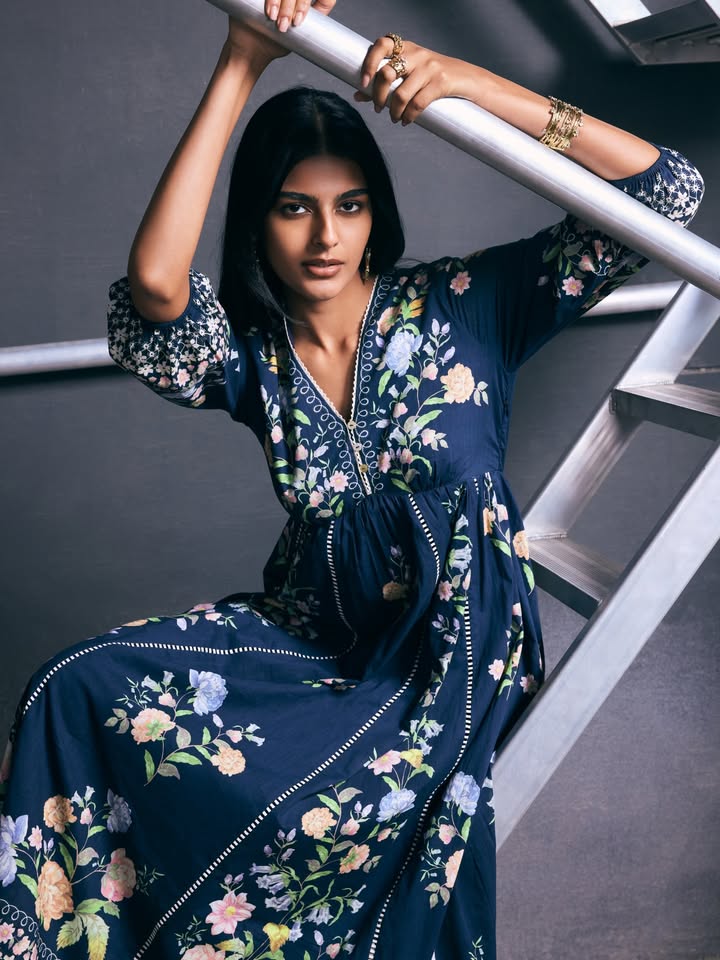Moody florals scattered across deep midnight hues, framed with delicate borders and soft volume