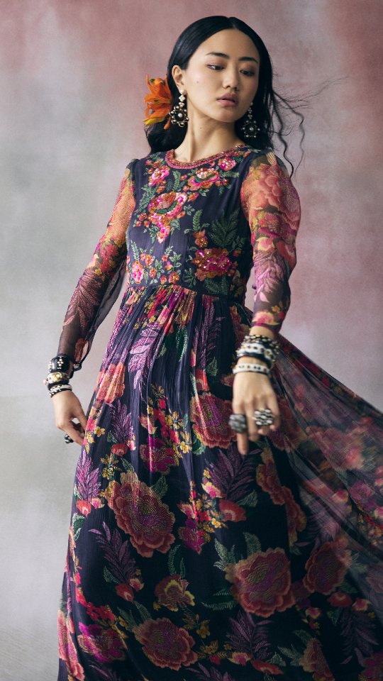 A canvas of hand painted blooms, brought to life with delicate sequins and flowing chiffon