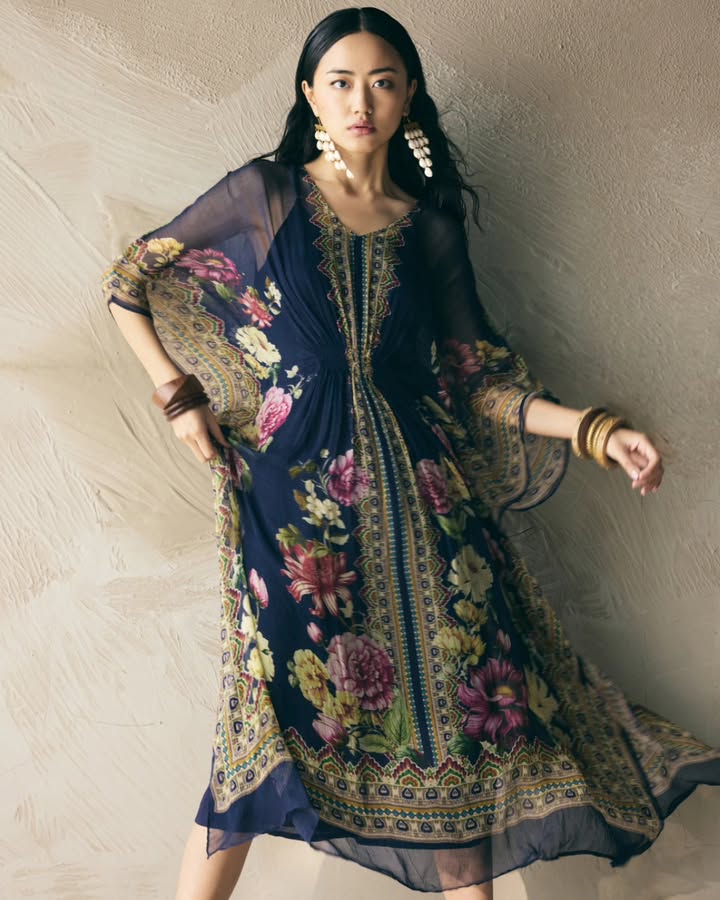 Bold florals meet fluid form. This kaftan is designed for elegant evenings and easy summer days