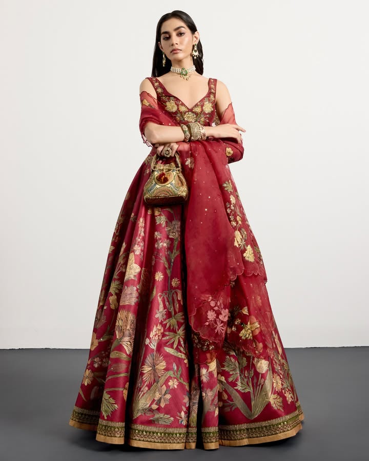 A vision in scarlet contrasted with tones of muted gold and natural hues, this lehenga draws inspiration from Parisian woode...