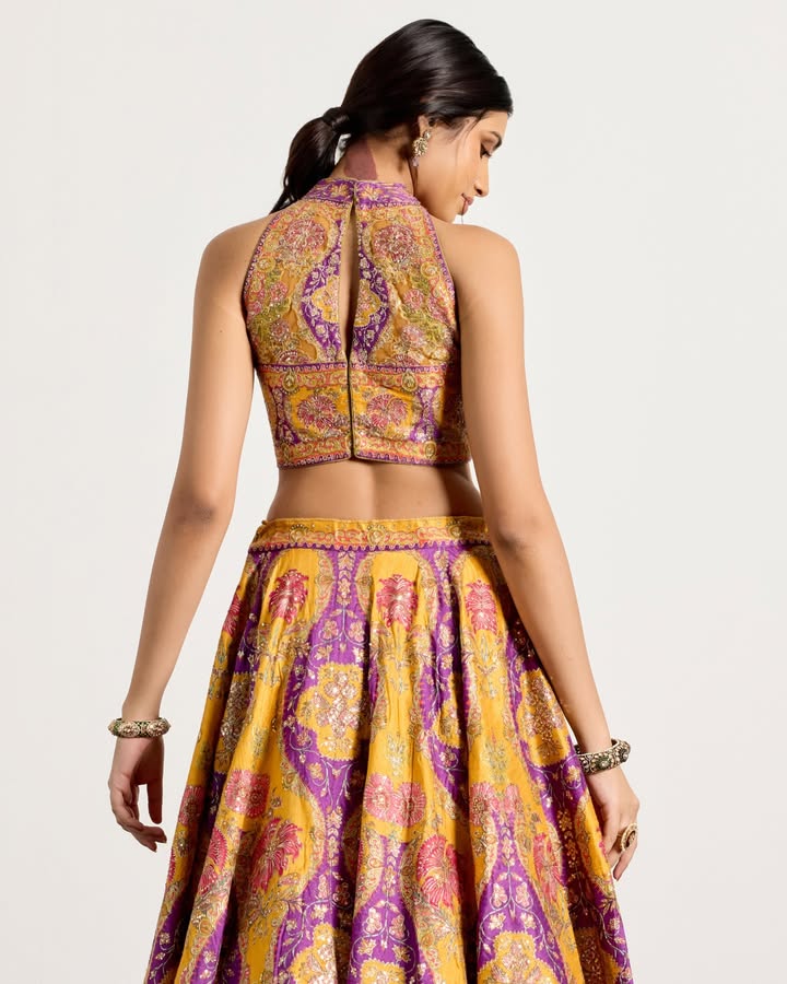 A vibrant ensemble designed for springtime celebrations, the Morina lehenga set incorporates subtle aari tikki embroidery wi...