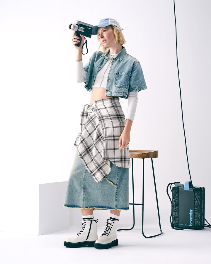 Ft. Ancha The Photographer Framed in a crisp white top, denim on denim, and a flannel nonchalantly tied at the waist